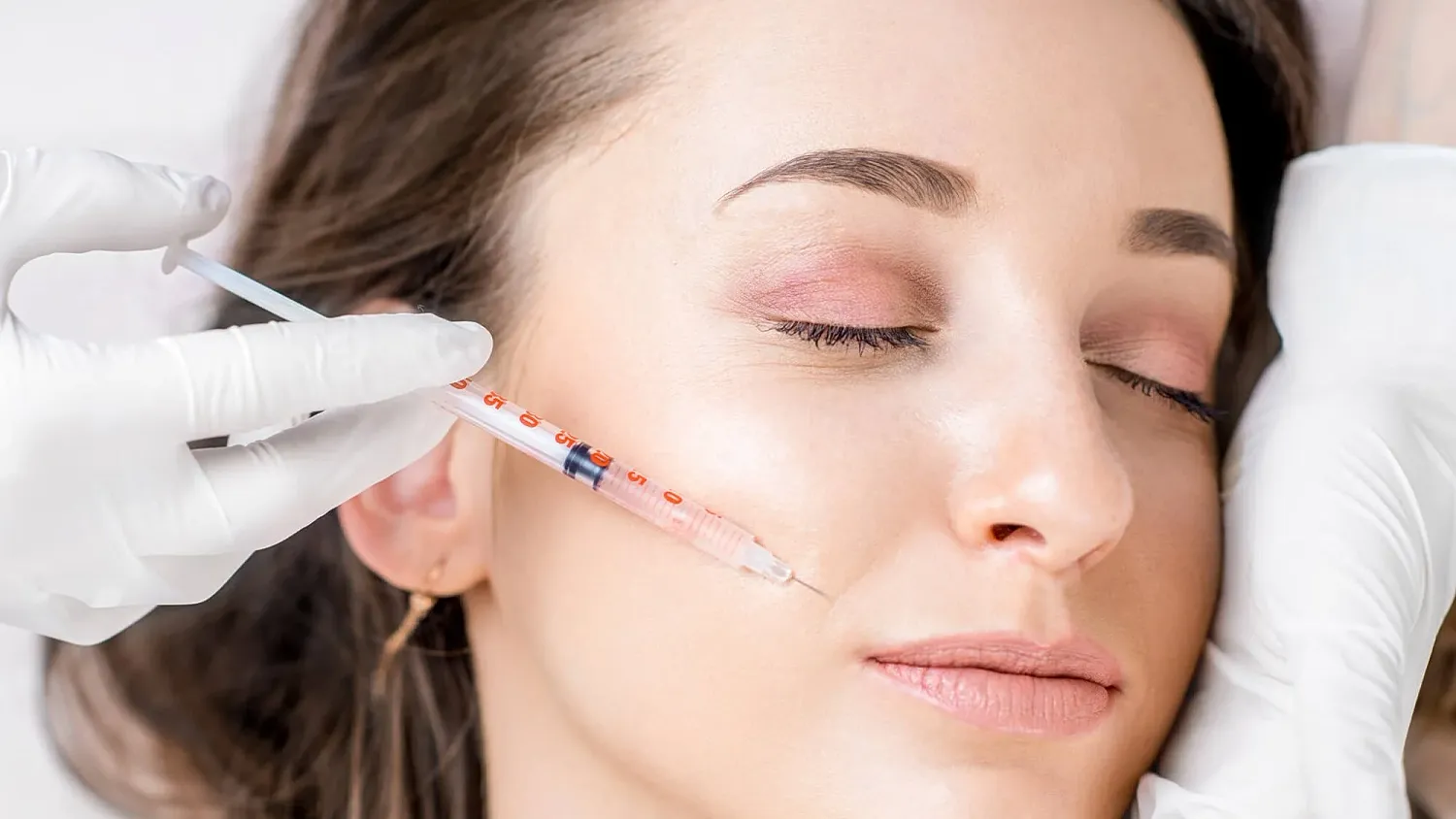 Woman receiving facial injection in beauty treatment.