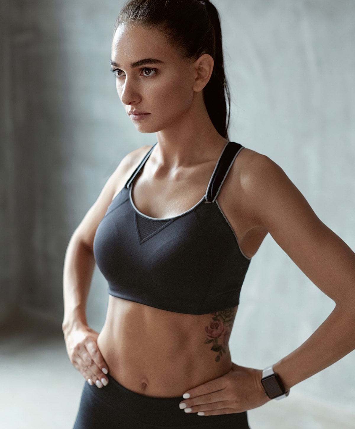 Fitness model in activewear, confident pose.