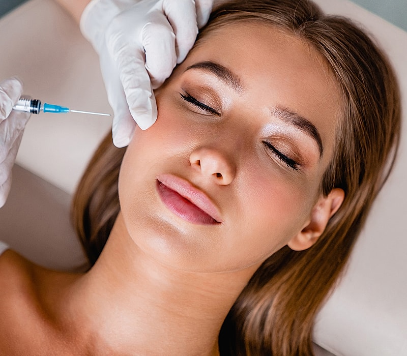 Woman receiving a facial injection treatment.