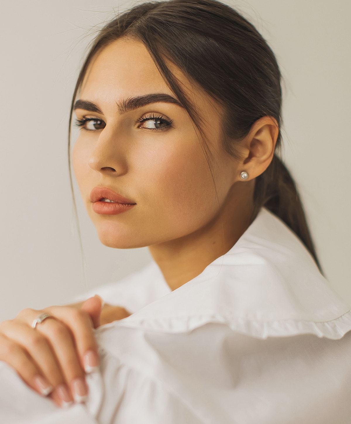 Portrait of a woman in a white shirt.