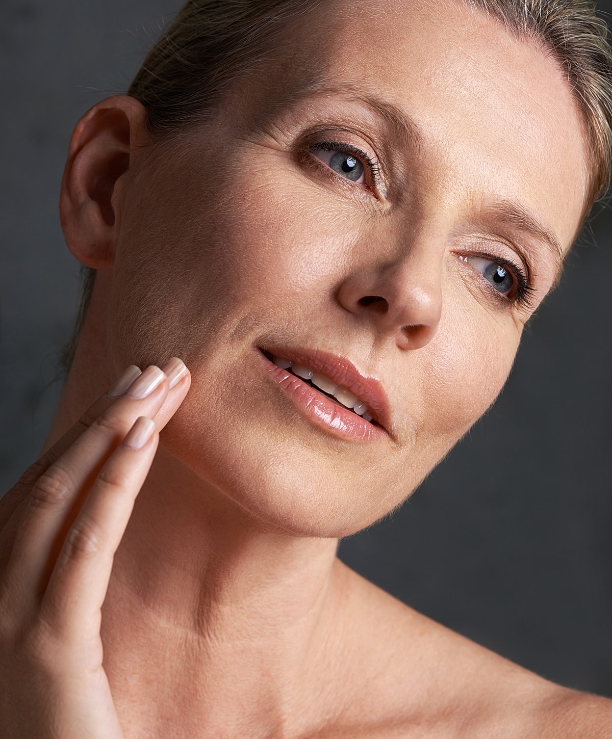 Woman touching her face, natural beauty shot.
