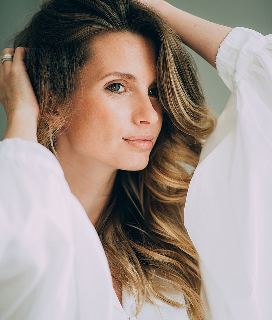 Woman with long hair in white blouse.