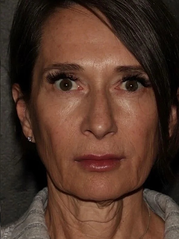 Woman with serious expression and long hair.