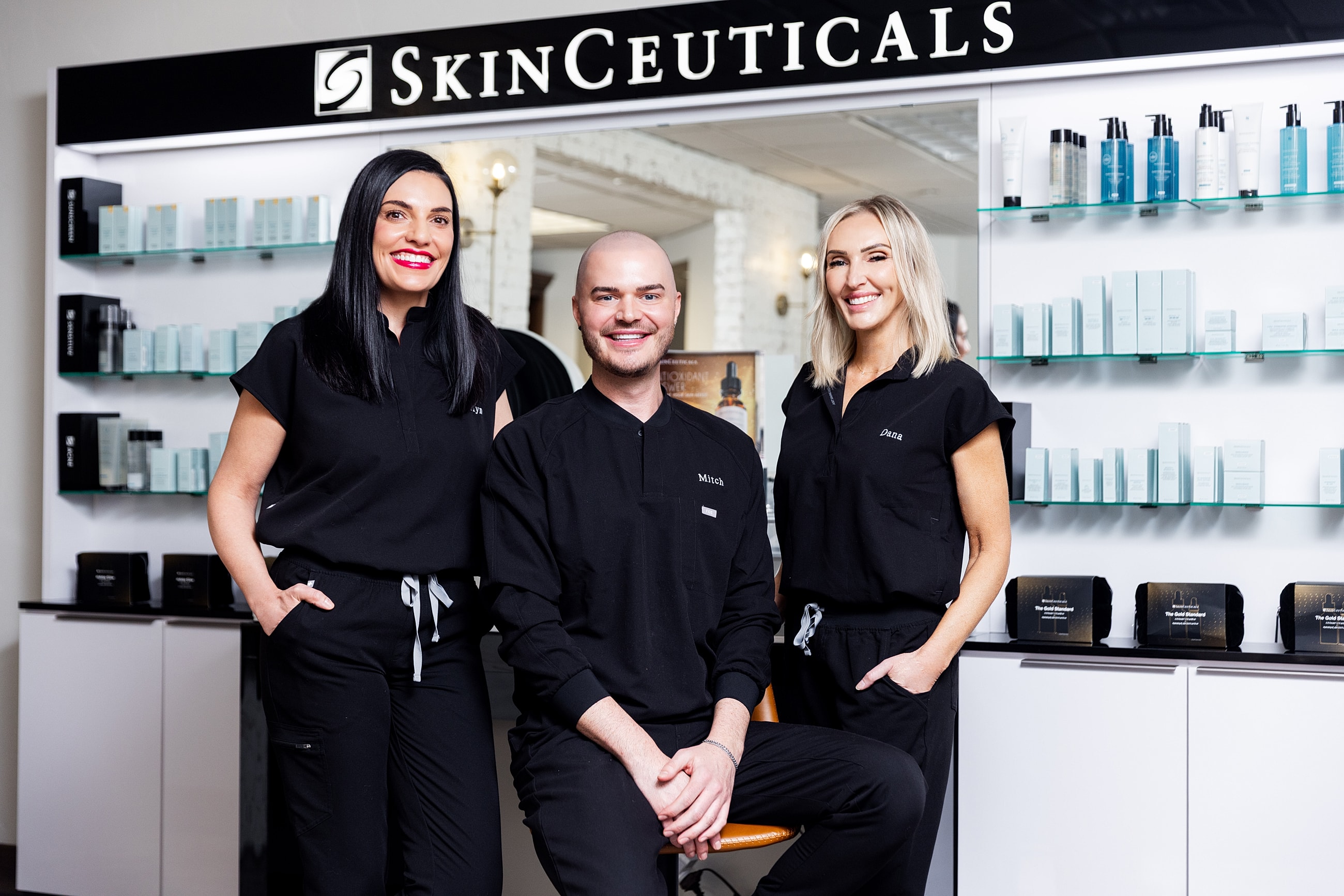 Woman applying skincare in a bright bathroom.