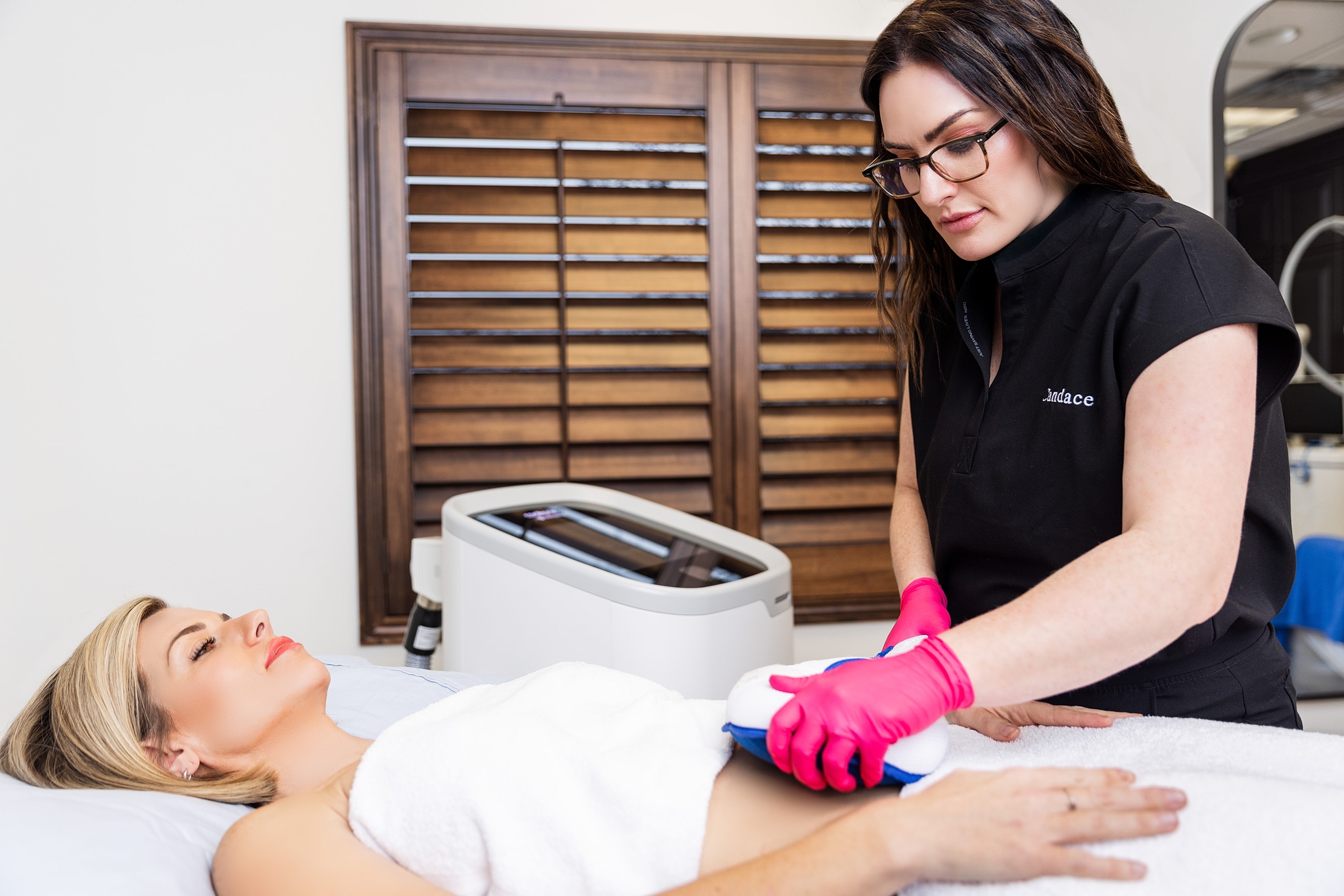 Woman in athletic wear posing against minimalist background.