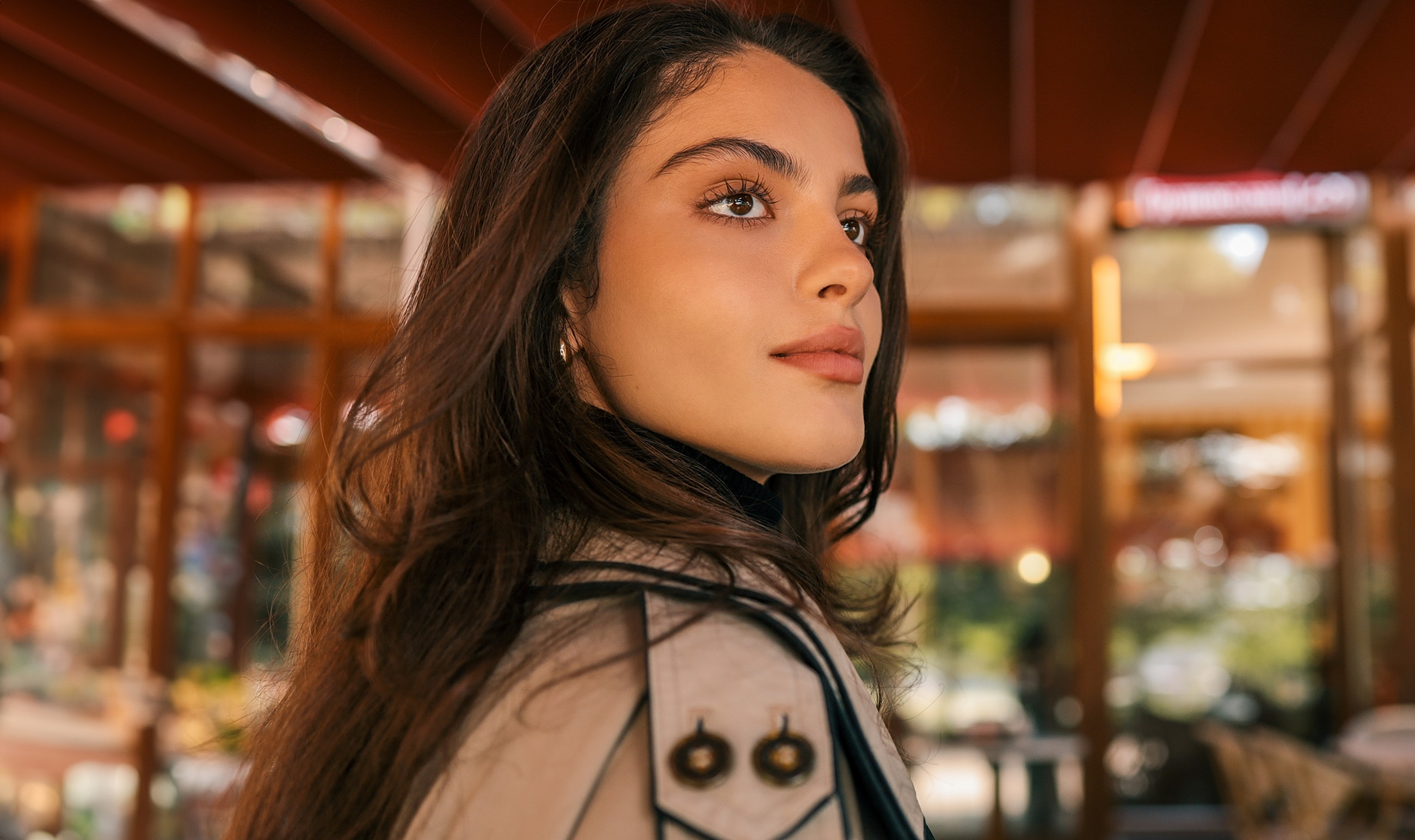 Woman with long hair in a stylish outfit.